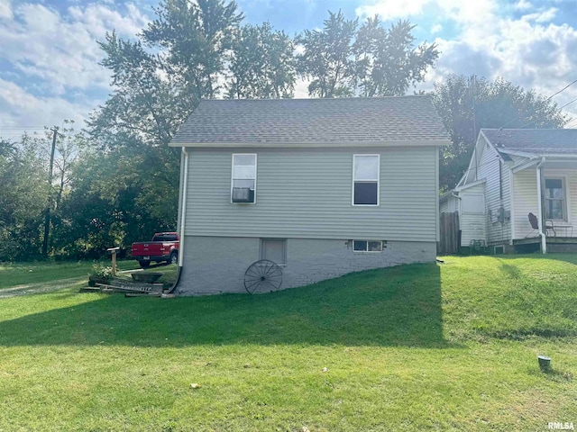 view of side of home with a yard