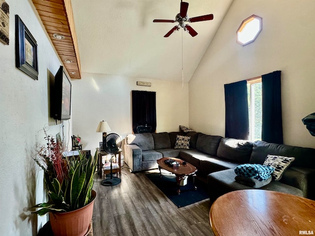 living room featuring dark hardwood / wood-style floors, ceiling fan, and high vaulted ceiling