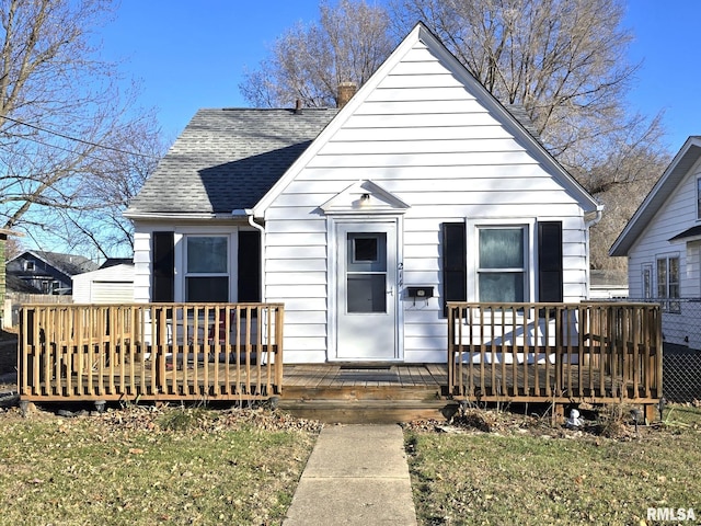 bungalow-style home with a wooden deck