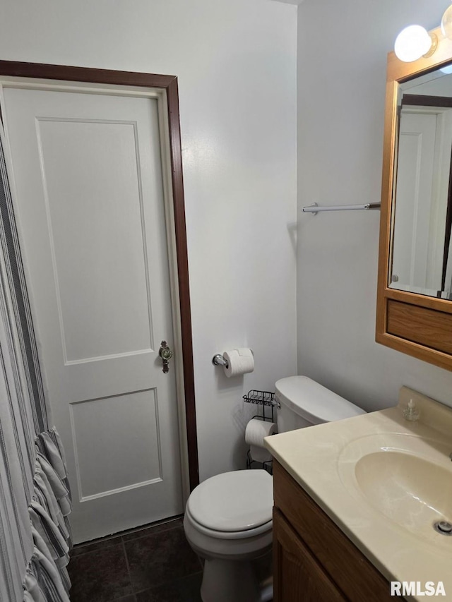 bathroom featuring tile patterned floors, vanity, and toilet