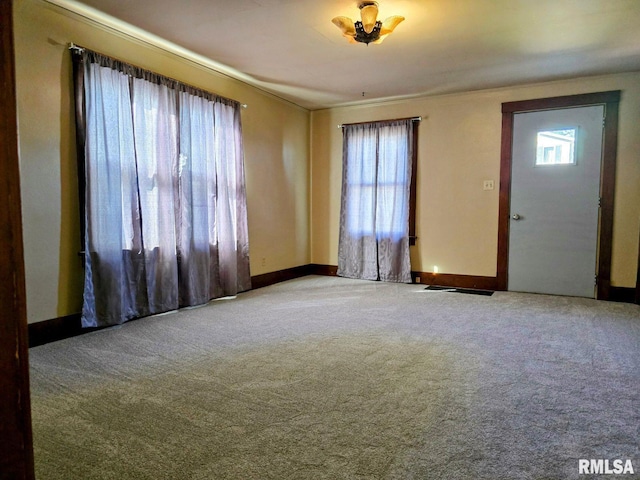 foyer with carpet flooring