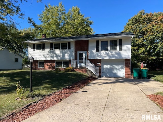 raised ranch with a front lawn and a garage