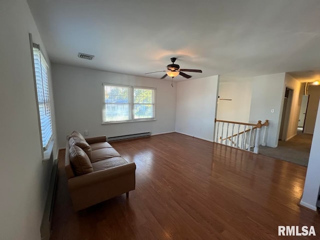 living room with ceiling fan, dark hardwood / wood-style floors, and a baseboard heating unit