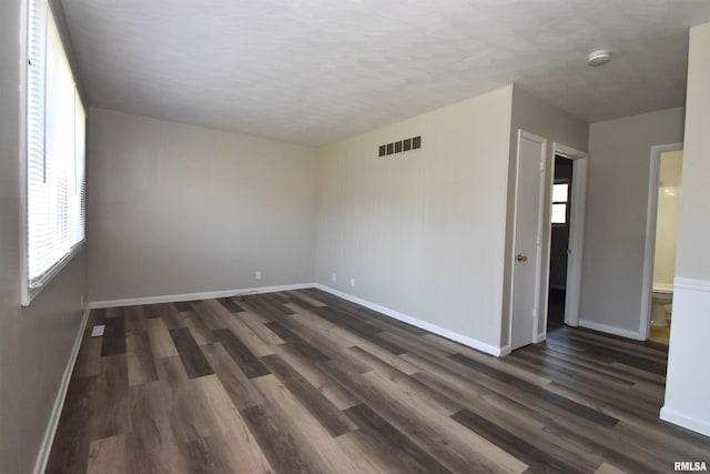 empty room featuring dark wood-type flooring