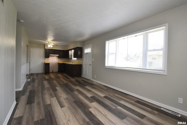 kitchen with dark hardwood / wood-style floors, ceiling fan, dark brown cabinetry, and sink