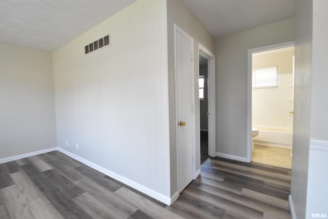 hallway with dark wood-type flooring