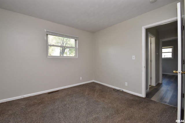 carpeted empty room with a healthy amount of sunlight