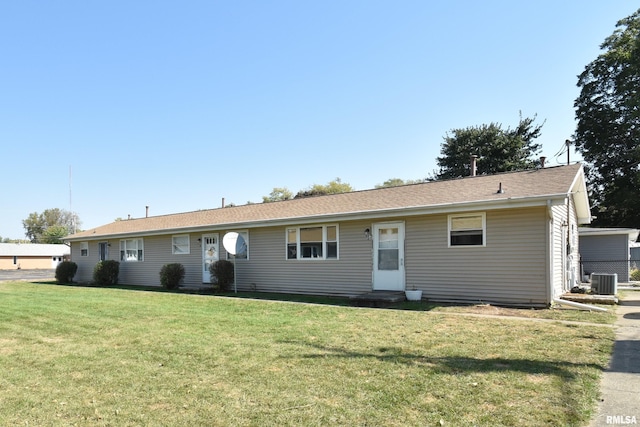 view of front facade with central AC and a front lawn