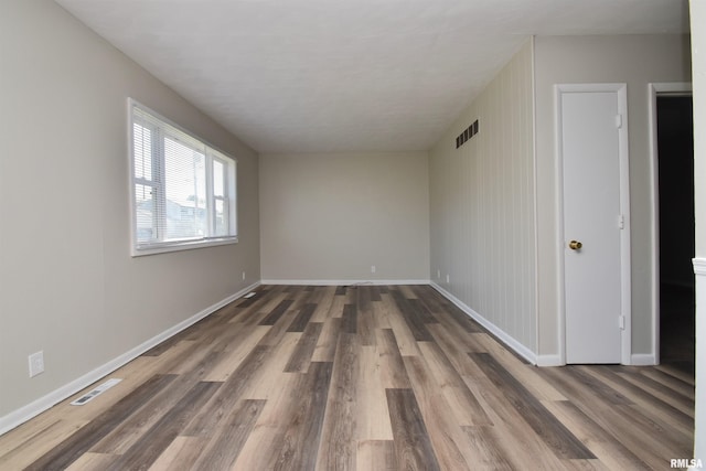 empty room featuring dark hardwood / wood-style flooring