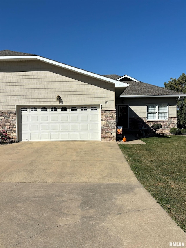 view of front facade with a garage and a front lawn