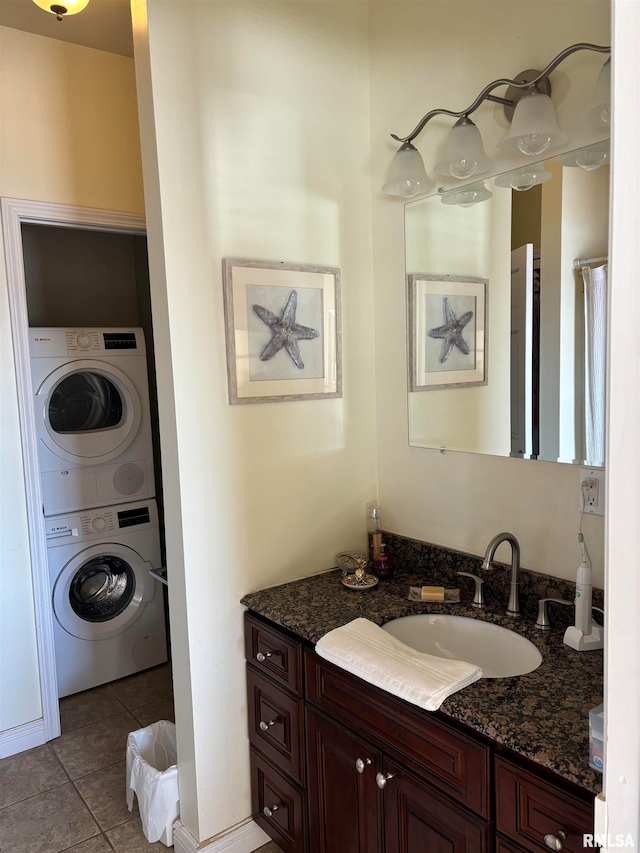 bathroom with vanity, tile patterned flooring, and stacked washer / drying machine