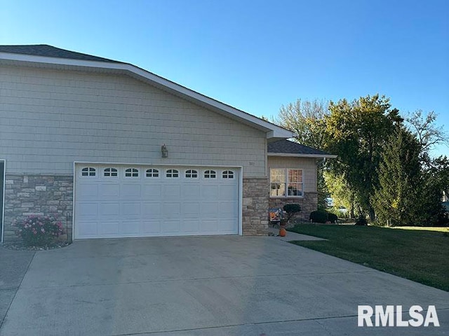 view of property exterior featuring a garage and a yard