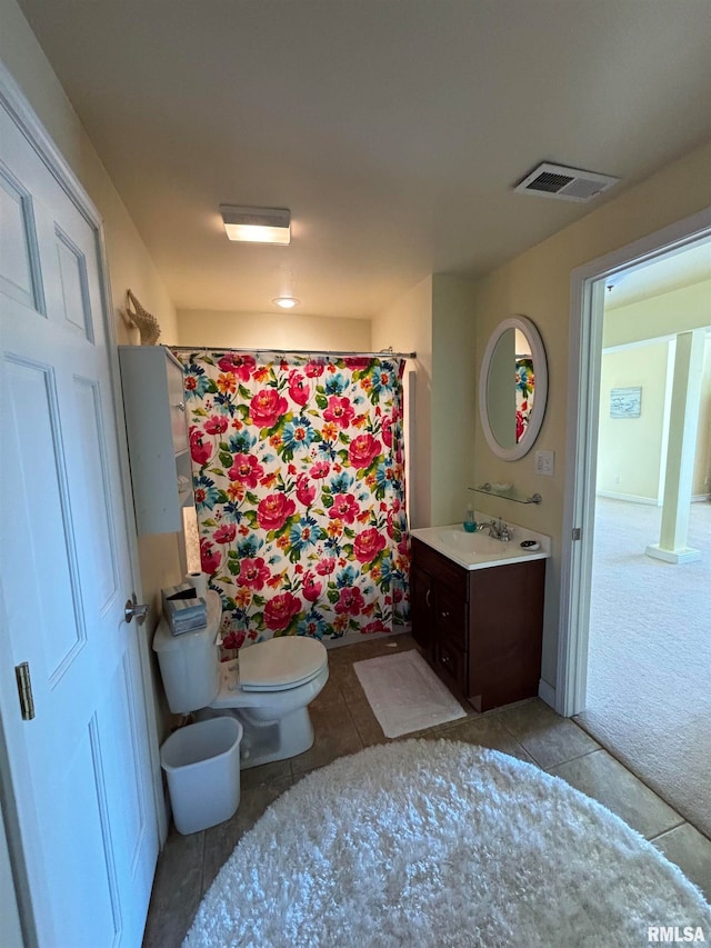 bathroom with vanity, tile patterned flooring, toilet, and curtained shower