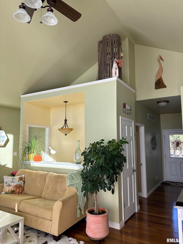 living room featuring vaulted ceiling and dark hardwood / wood-style flooring