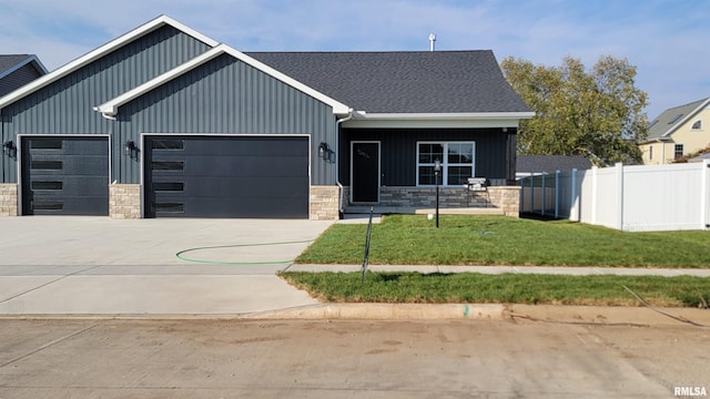 view of front of property featuring a garage and a front lawn