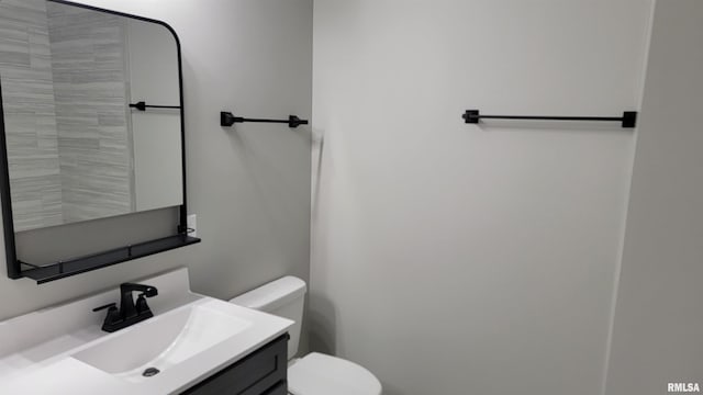 bathroom with toilet and vanity