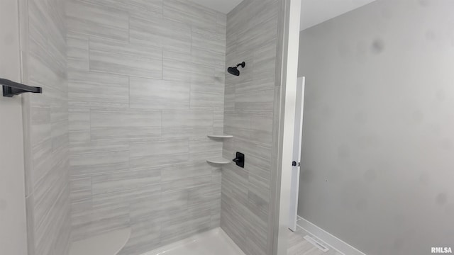 bathroom with a tile shower