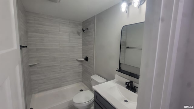 bathroom with vanity, toilet, and a tile shower