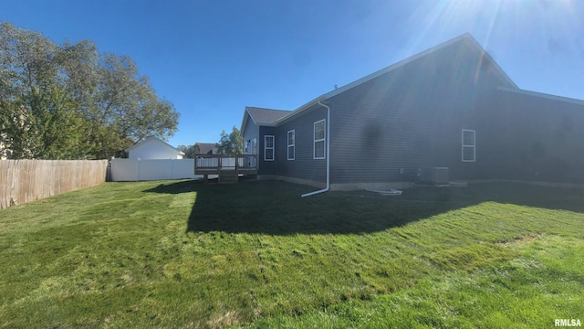 view of yard featuring central air condition unit and a wooden deck