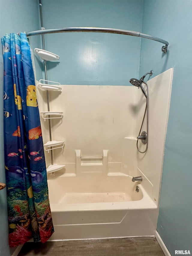 bathroom featuring shower / bath combo with shower curtain and hardwood / wood-style floors