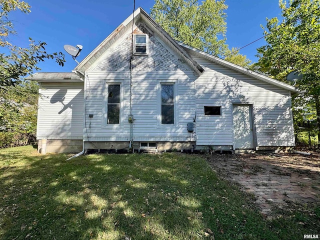 rear view of house with a lawn