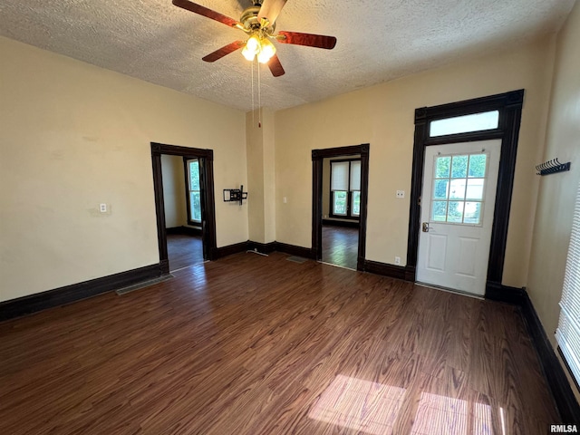 entrance foyer with dark hardwood / wood-style flooring, ceiling fan, and a textured ceiling