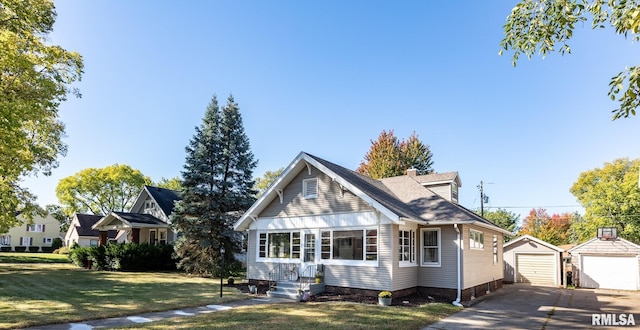 view of front of property featuring a front lawn, a garage, and an outdoor structure