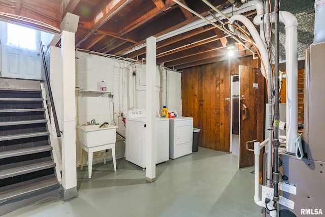 basement with washing machine and clothes dryer and sink