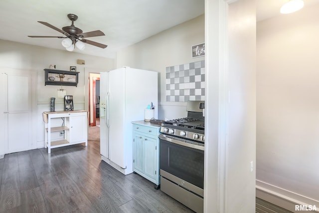 kitchen featuring stainless steel gas stove, white fridge with ice dispenser, dark hardwood / wood-style flooring, and ceiling fan