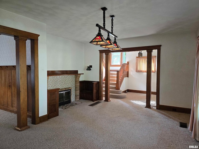 unfurnished living room featuring a textured ceiling, a tiled fireplace, and carpet