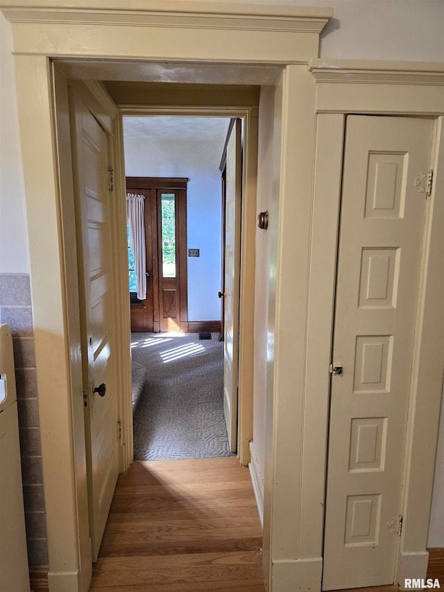 hall with wood-type flooring