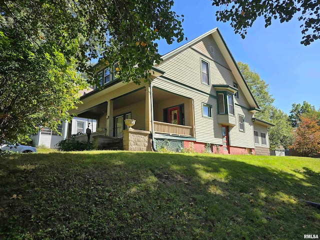 view of property exterior with a porch and a yard