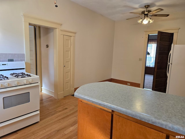 kitchen with light wood-type flooring, ceiling fan, and white appliances