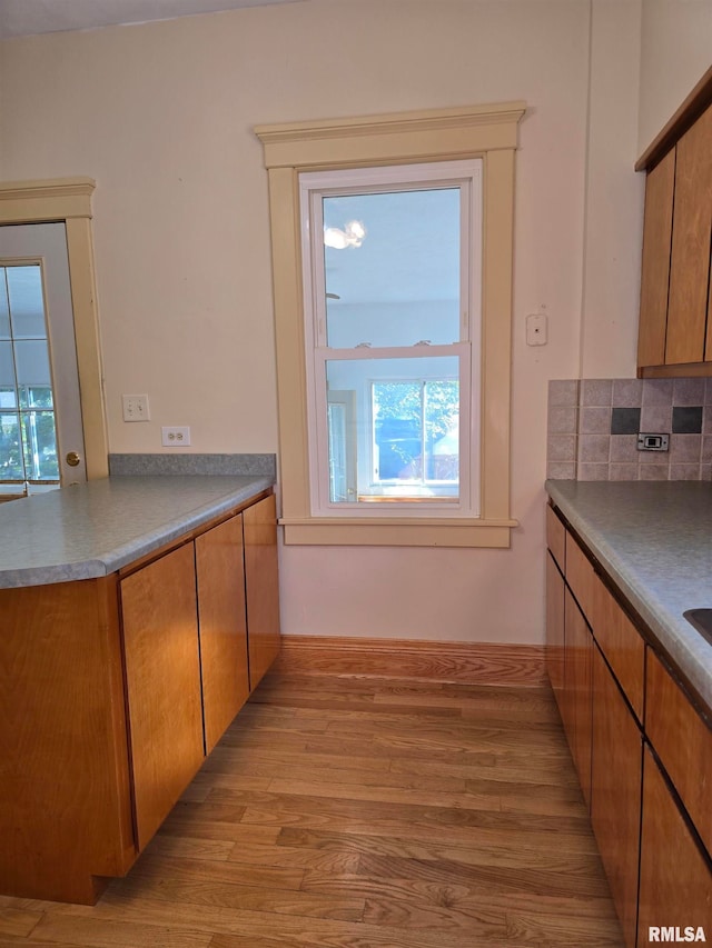 kitchen featuring light wood-type flooring and tasteful backsplash