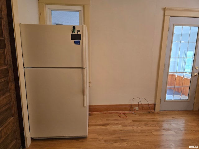 kitchen with light hardwood / wood-style floors, white fridge, and a healthy amount of sunlight