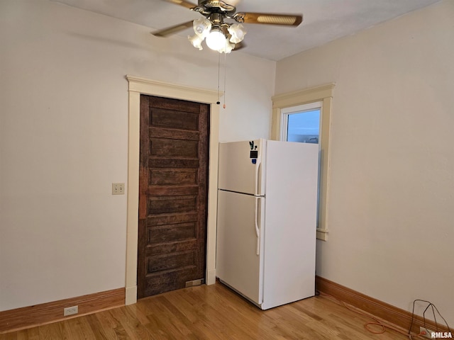 kitchen with white fridge, ceiling fan, and light hardwood / wood-style floors