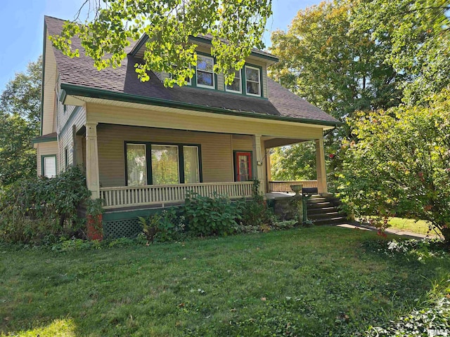 view of front of house featuring a front yard and covered porch