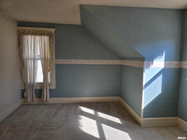 bonus room with a textured ceiling