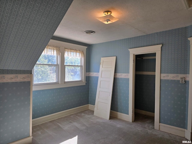 unfurnished bedroom with carpet flooring and a textured ceiling