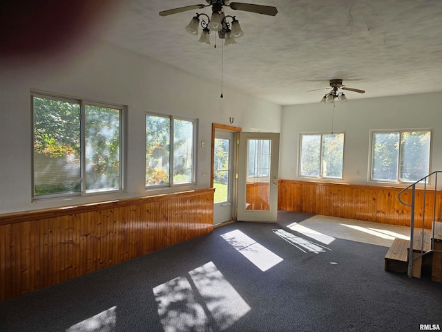 unfurnished sunroom with ceiling fan and plenty of natural light