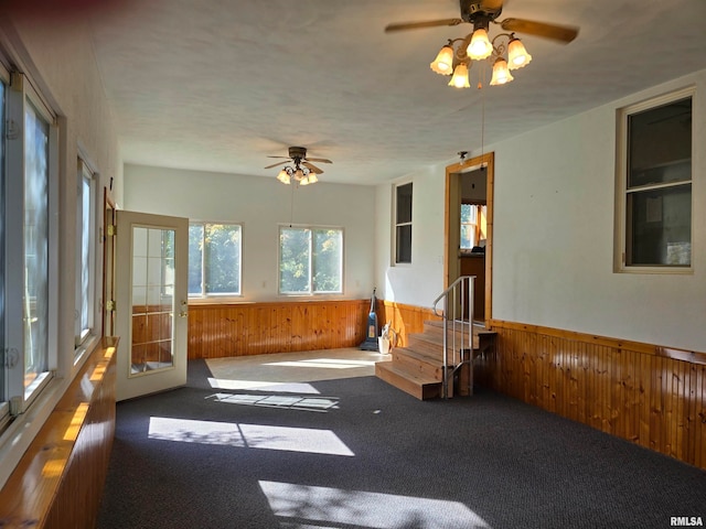 unfurnished sunroom with ceiling fan