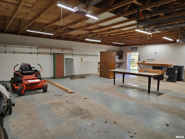 garage featuring a garage door opener and a workshop area