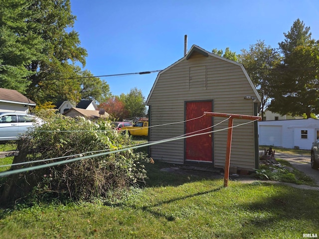 view of outbuilding featuring a yard