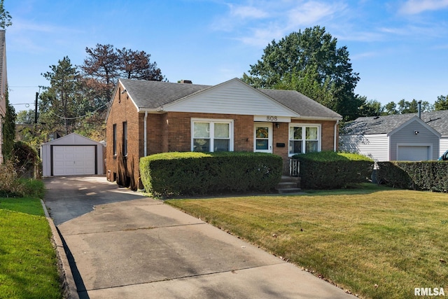 view of front of house with a front yard, a garage, and an outdoor structure