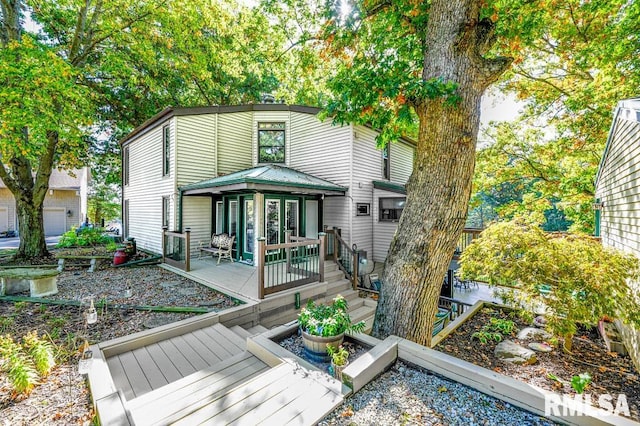 back of house featuring a deck