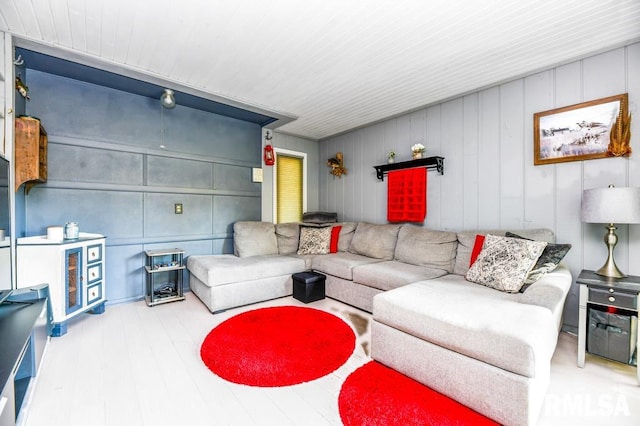 living room featuring hardwood / wood-style floors and wood walls