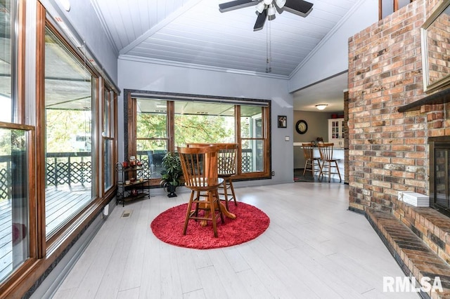 sunroom / solarium with lofted ceiling, ceiling fan, and wood ceiling