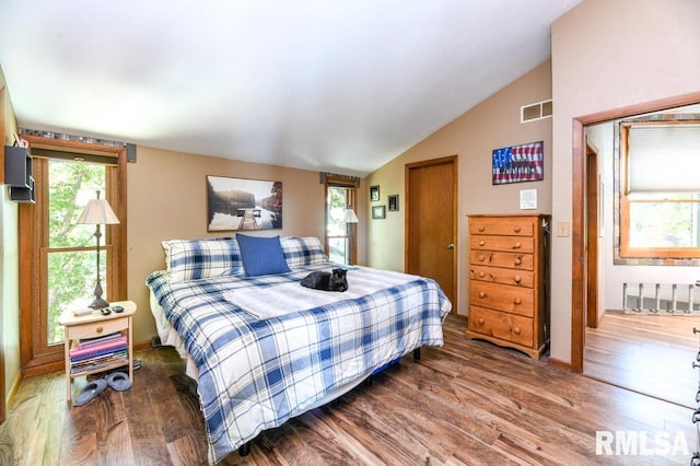 bedroom featuring dark hardwood / wood-style floors and vaulted ceiling