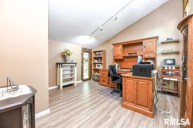 office space featuring rail lighting, light hardwood / wood-style floors, and lofted ceiling