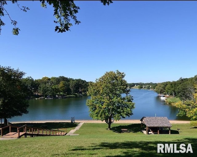 dock area featuring a water view and a yard